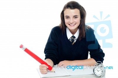 Smiling Schoolgirl Holding Pencil Stock Photo