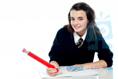 Smiling Schoolgirl Holding Pencil Stock Photo