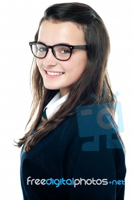 Smiling schoolgirl wearing glasses Stock Photo