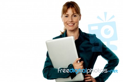 Smiling Secretary Holding Laptop Stock Photo