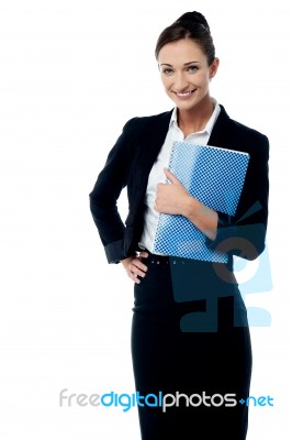 Smiling Secretary Holding Spiral Notebook Stock Photo