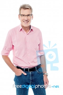 Smiling Senior Man With Hand In His Pocket Stock Photo