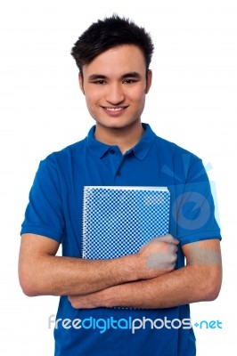 Smiling Student Embracing His Note Book Stock Photo