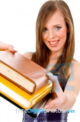 Smiling Student Showing Books Stock Photo