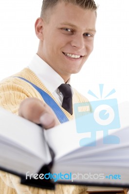 Smiling Student Showing His Book Stock Photo