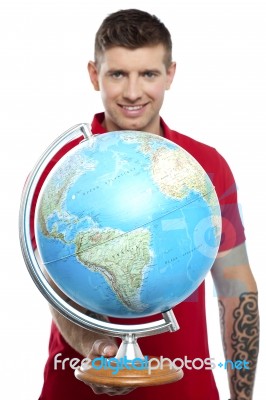 Smiling Tattoo Guy Showing Globe Stock Photo