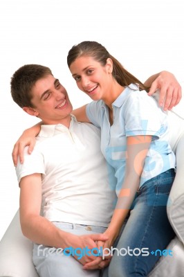 Smiling Teenage Couple Sitting Stock Photo