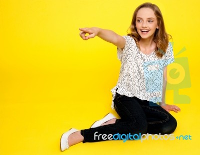 Smiling Teenage Girl Pointing Side Stock Photo