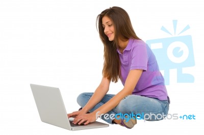 Smiling Teenage Girl Using Laptop Stock Photo