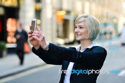 Smiling Woman Capturing A Self Shot Stock Photo