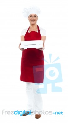 Smiling Woman Chef Offering Box Stock Photo