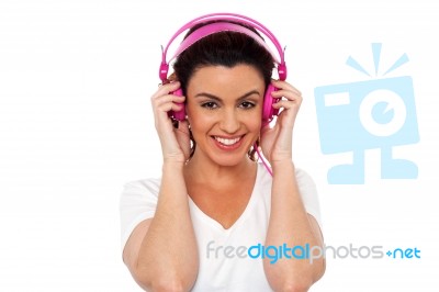 Smiling Woman Enjoying Music Stock Photo