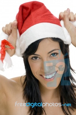 Smiling Woman Holding Santa Hat Stock Photo