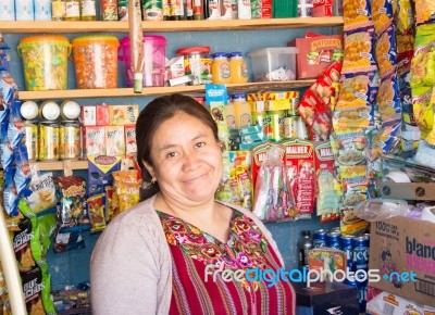 Smiling Woman In Front Of Corner Store In Small Town In Guatemal… Stock Photo