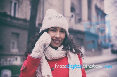 Smiling Woman In Red And Wool Cap And Gloves With Smartphone In Stock Photo