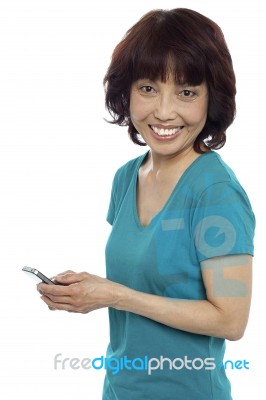 Smiling Woman Messaging Her Friends Stock Photo