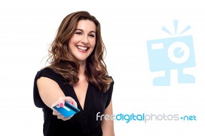 Smiling Woman Offering You A Credit Card Stock Photo