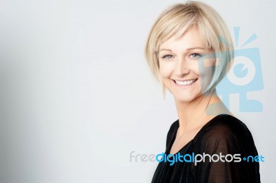 Smiling Woman On A Grey Background Stock Photo