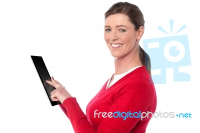 Smiling Woman Operating Touch Pad Device Stock Photo