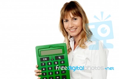 Smiling Woman Showing Big Calculator Stock Photo