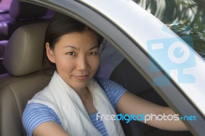 Smiling Woman Sitting In Car Stock Photo