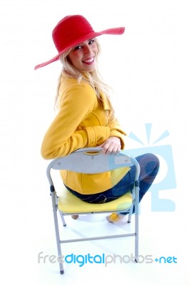 Smiling Woman Sitting On Chair Stock Photo