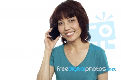 Smiling Woman Talking Over Phone Stock Photo