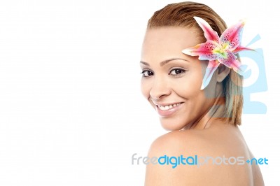 Smiling Woman With Pink Lily Flower Stock Photo