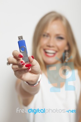 Smiling Woman With Usb Memory Stick In Hands Stock Photo