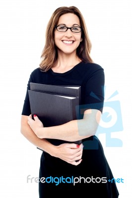 Smiling Women Holding Folder In Hand Stock Photo