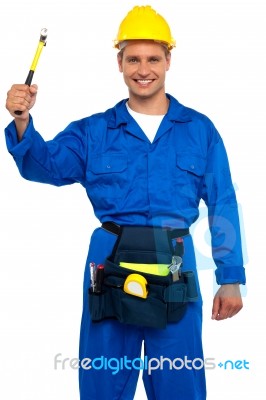 Smiling Worker Holding Hammer Stock Photo