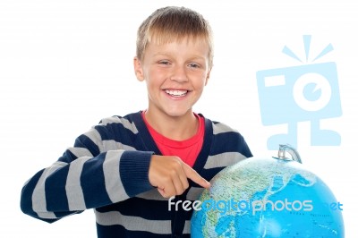 Smiling Young Boy With Globe Stock Photo