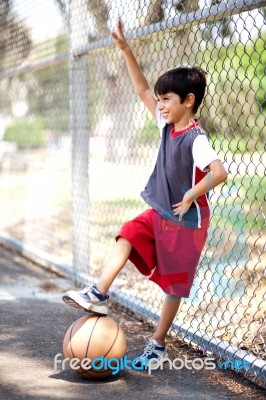 Smiling Young Boy With His Basketball Stock Photo