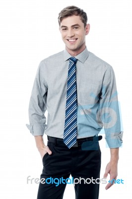 Smiling Young Businessman Standing Stock Photo