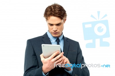 Smiling Young Businessman Using Touchpad Stock Photo