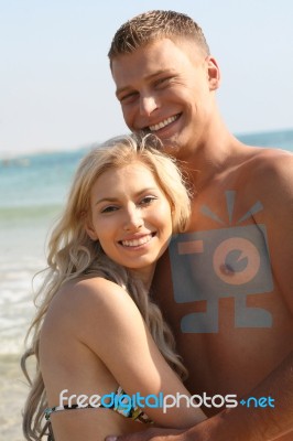 Smiling Young Couple At Beach Stock Photo