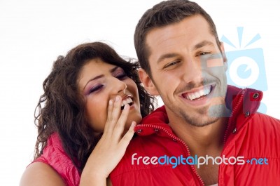 Smiling Young Couple Whispering Stock Photo