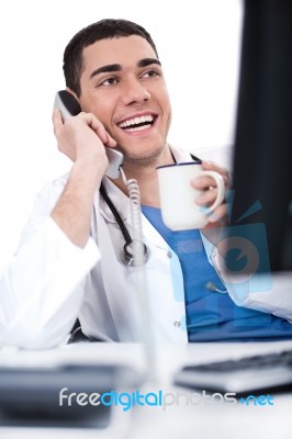 Smiling Young Doctor Over Phone Stock Photo