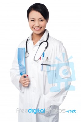 Smiling Young Doctor With A Folder Stock Photo