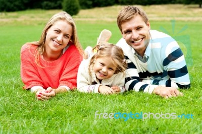 Smiling Young Family In Outdoors Stock Photo