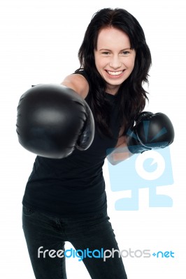 Smiling Young Female Boxer Ready To Punch You Stock Photo