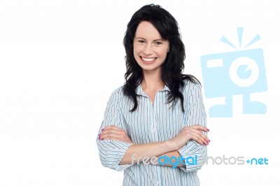 Smiling Young Girl Posing Casually, Arms Crossed Stock Photo