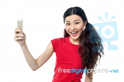 Smiling Young Girl Taking A Selfie Stock Photo