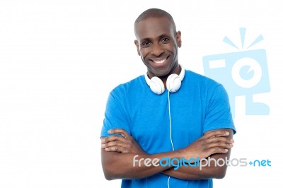 Smiling Young Guy Hanging Headphones In His Neck Stock Photo