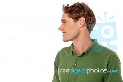 Smiling Young Guy Looking Away Stock Photo