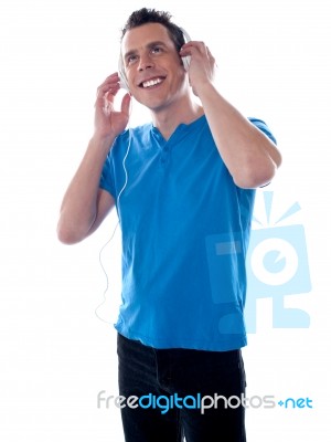 Smiling Young Male Listening Music Stock Photo