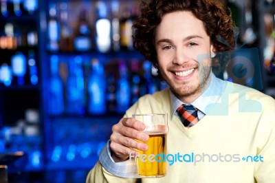 Smiling Young Man Holding A Glass Of Beer Stock Photo