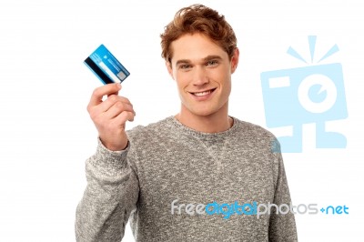 Smiling Young Man Holding Credit Card Stock Photo