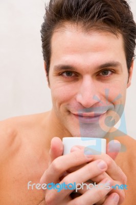 Smiling Young Man Holding Cup Stock Photo