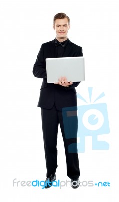 Smiling Young Man Holding Laptop Stock Photo